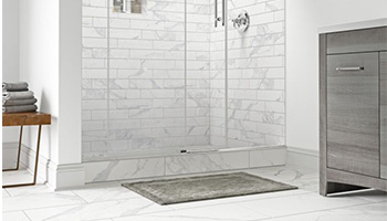 Using the same tiles for the entire layout of bathroom makes it look bigger Using the same tiles for the entire layout of bathroom makes it look bigger