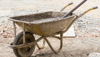 Using wheelbarrel to transport concrete mix