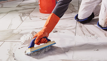 Applying grout on the tiles